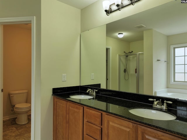 full bathroom featuring vanity, toilet, and separate shower and tub