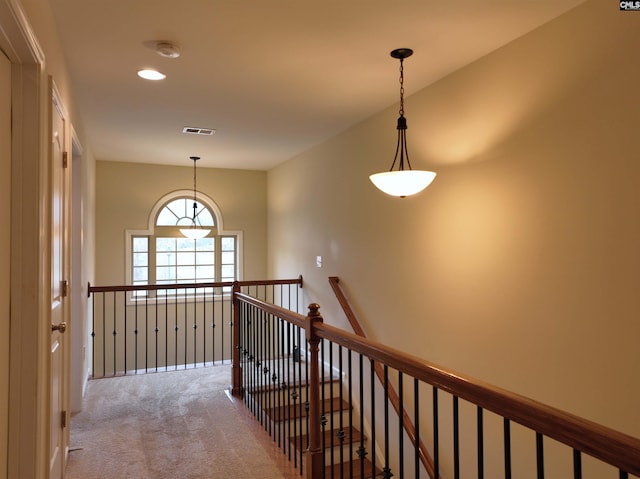 corridor with light colored carpet