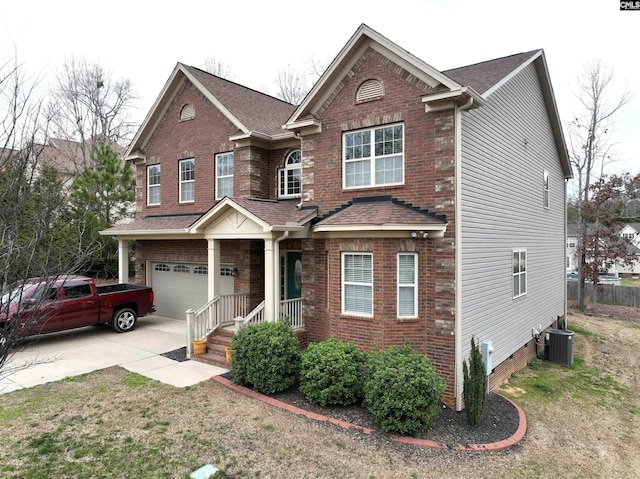 view of front facade with a garage and central air condition unit