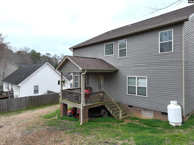 rear view of property with a wooden deck and a yard