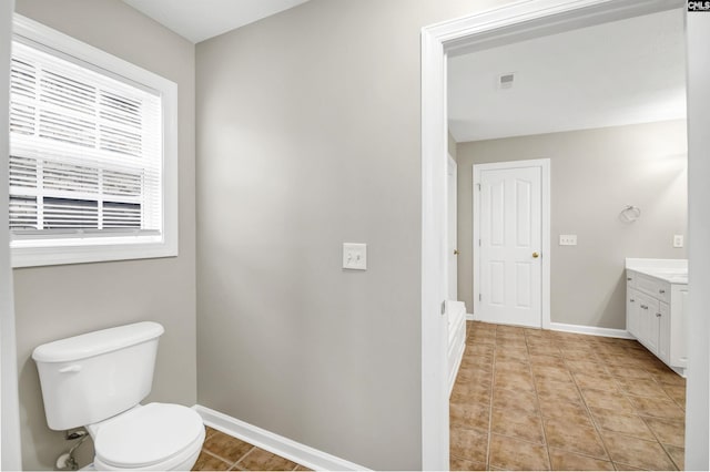 bathroom with tile patterned flooring, vanity, and toilet