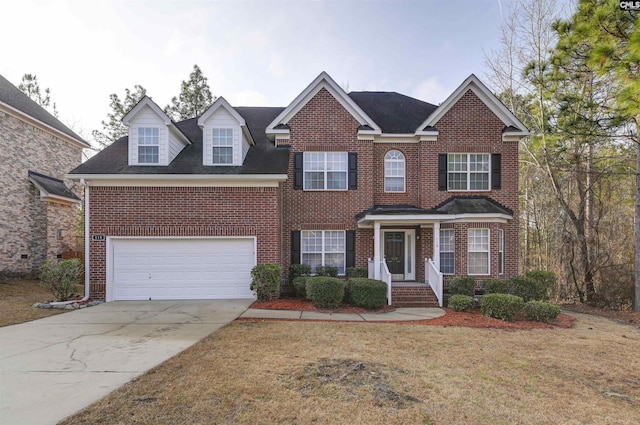 view of front of property with a garage and a front yard