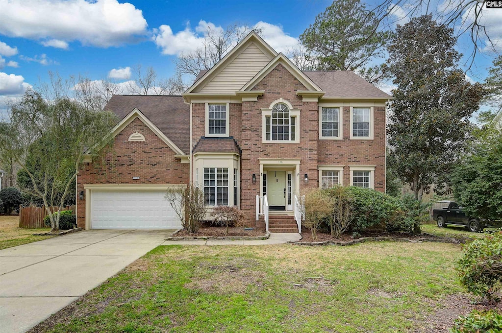 view of front of home featuring a garage and a front yard