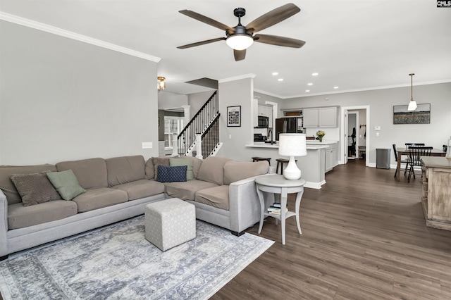 living room with ceiling fan, ornamental molding, dark hardwood / wood-style floors, and sink