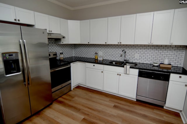 kitchen with stainless steel appliances, white cabinetry, and sink