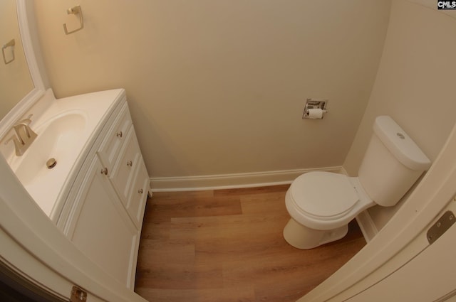 bathroom with vanity, wood-type flooring, and toilet