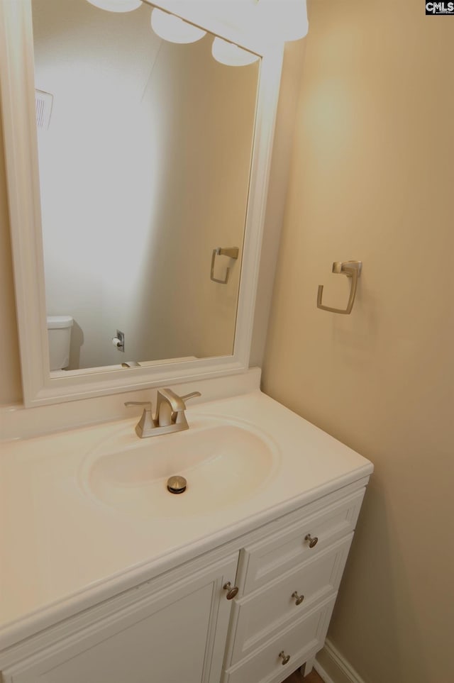 bathroom with vanity and toilet