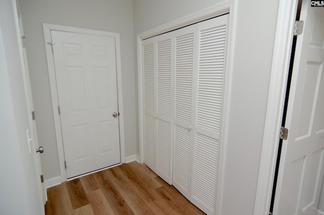 hallway with light hardwood / wood-style flooring