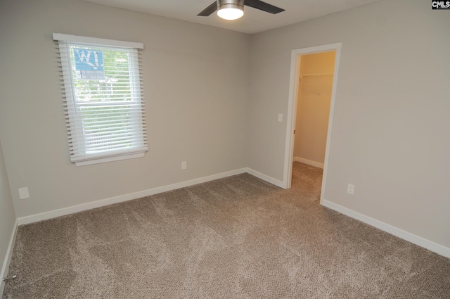 unfurnished room with carpet flooring and ceiling fan