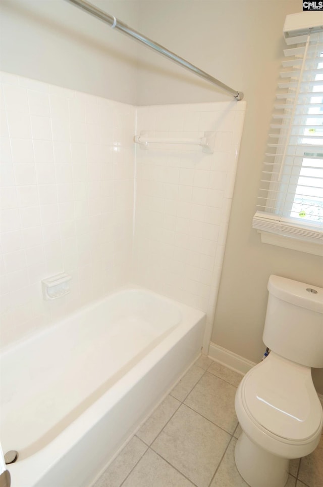 bathroom with tile patterned flooring and bathtub / shower combination