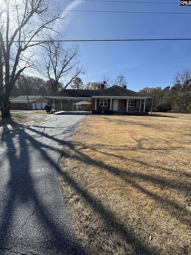 single story home with a carport and a front lawn