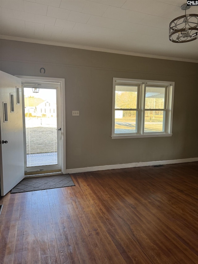 foyer entrance featuring ornamental molding and dark hardwood / wood-style floors