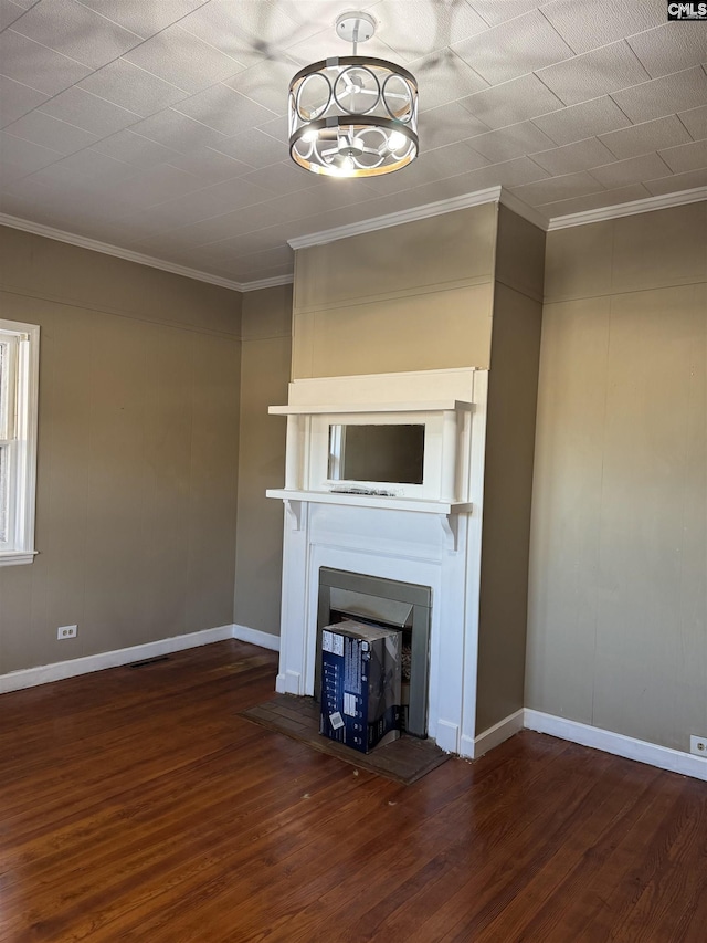 unfurnished living room featuring crown molding, a notable chandelier, and dark hardwood / wood-style flooring