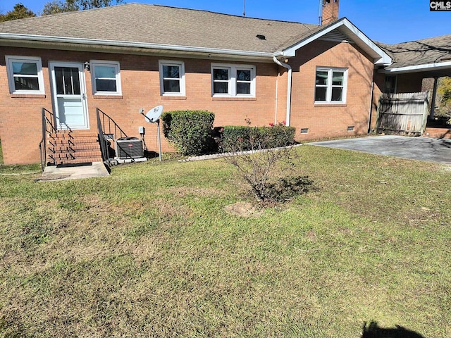 back of house with a patio, central AC unit, and a lawn