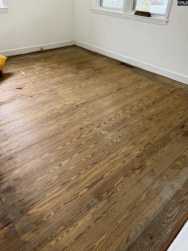 empty room with dark hardwood / wood-style floors