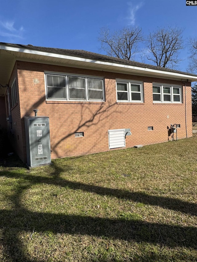 rear view of property with a lawn