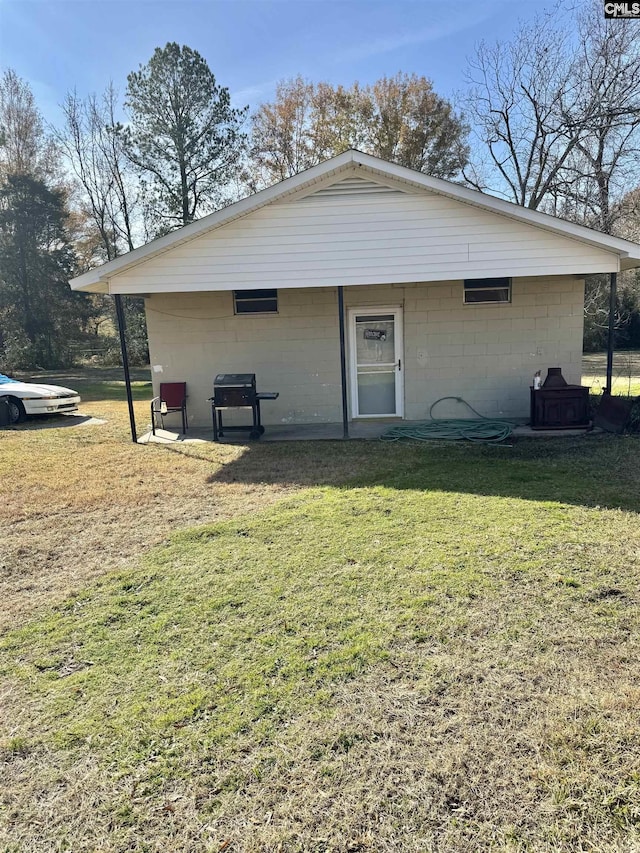 rear view of house featuring a yard