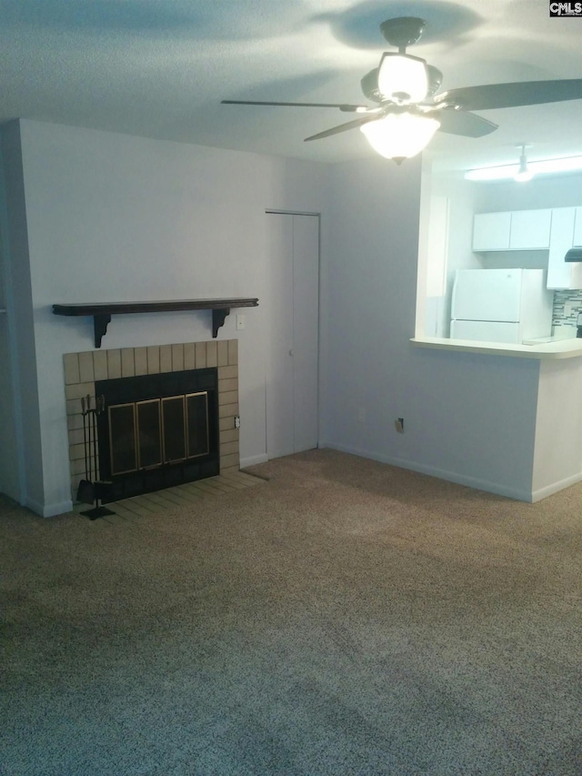 unfurnished living room featuring ceiling fan, carpet floors, and a fireplace