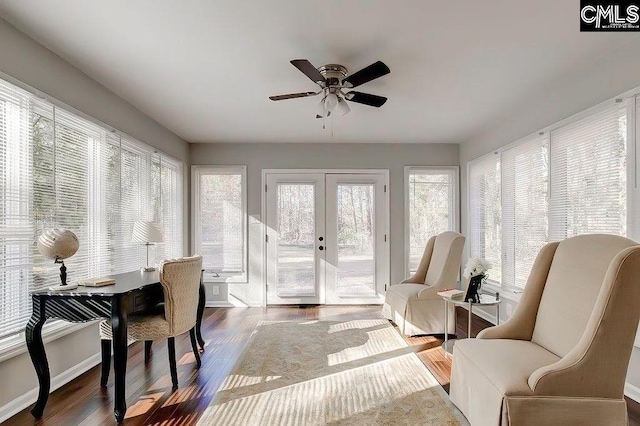 sunroom / solarium featuring french doors and ceiling fan