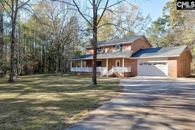 view of front of home with a garage, covered porch, and a front yard