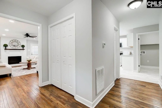 corridor with dark hardwood / wood-style floors