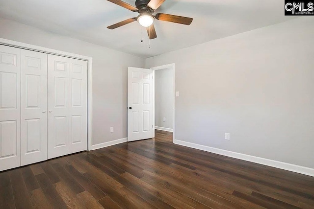 unfurnished bedroom with dark hardwood / wood-style floors, ceiling fan, and a closet