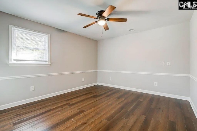 empty room featuring dark wood-type flooring and ceiling fan