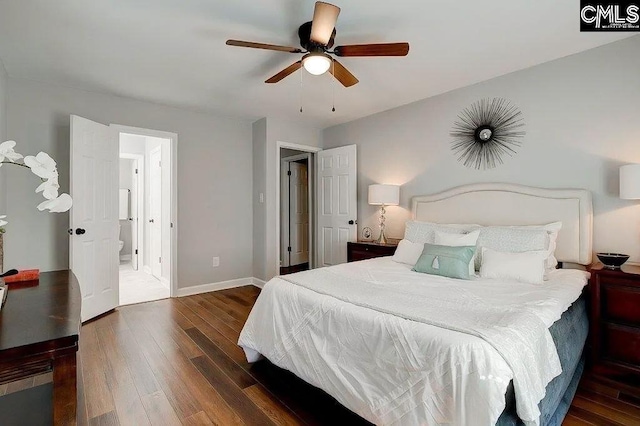 bedroom with dark wood-type flooring, ceiling fan, and connected bathroom