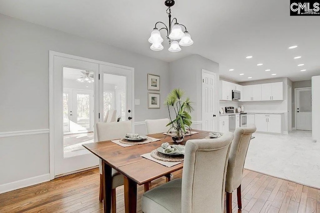 dining room with a chandelier and light hardwood / wood-style floors