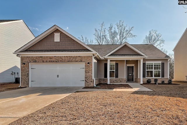 craftsman house featuring cooling unit, a garage, and a porch