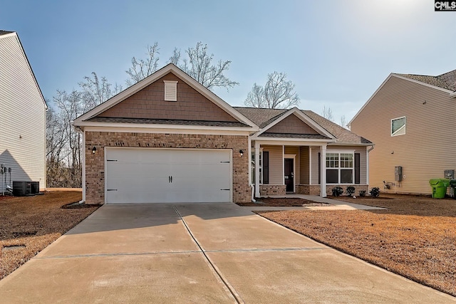 craftsman inspired home with a garage, central AC, and covered porch