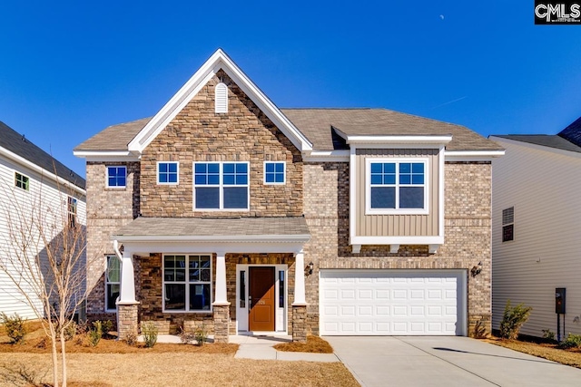 craftsman-style home with board and batten siding, brick siding, driveway, and a garage