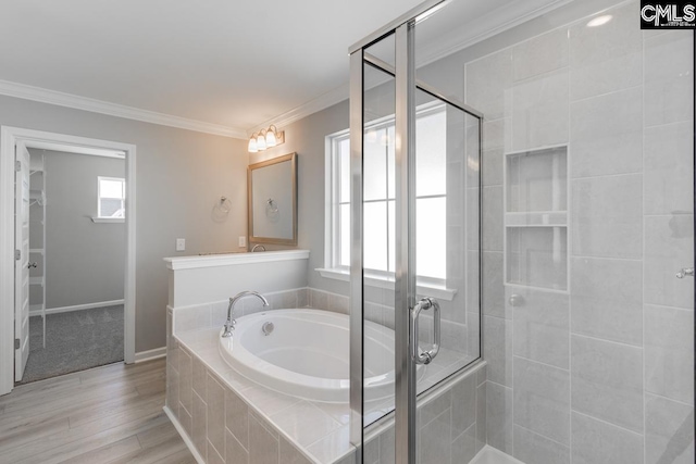 full bath featuring ornamental molding, a stall shower, and a healthy amount of sunlight