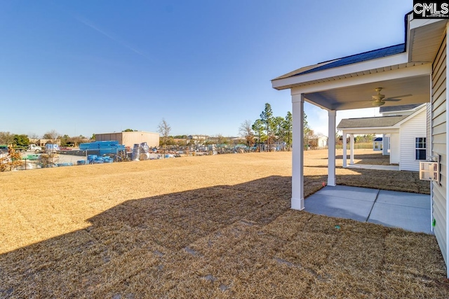 view of yard featuring a ceiling fan and a patio