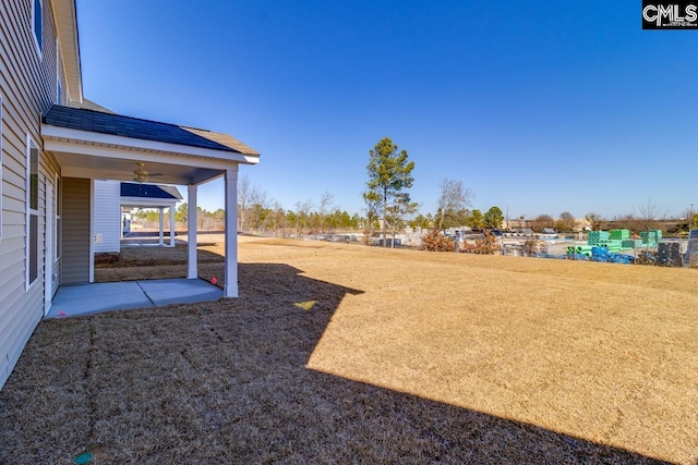 view of yard with a patio area and ceiling fan