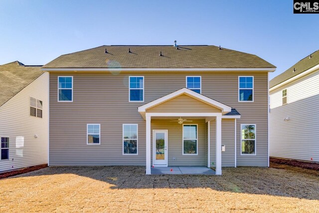 rear view of property with a ceiling fan and a patio