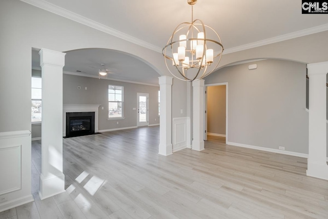 unfurnished living room with arched walkways, a fireplace with flush hearth, a ceiling fan, light wood finished floors, and decorative columns