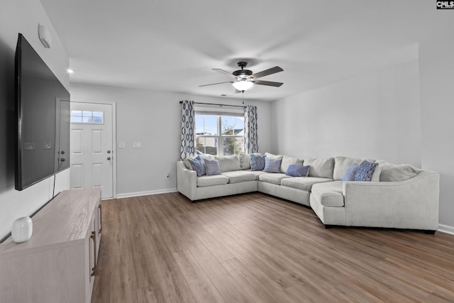 living room with wood-type flooring and ceiling fan