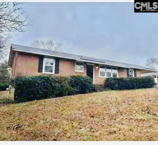 ranch-style house with a front lawn