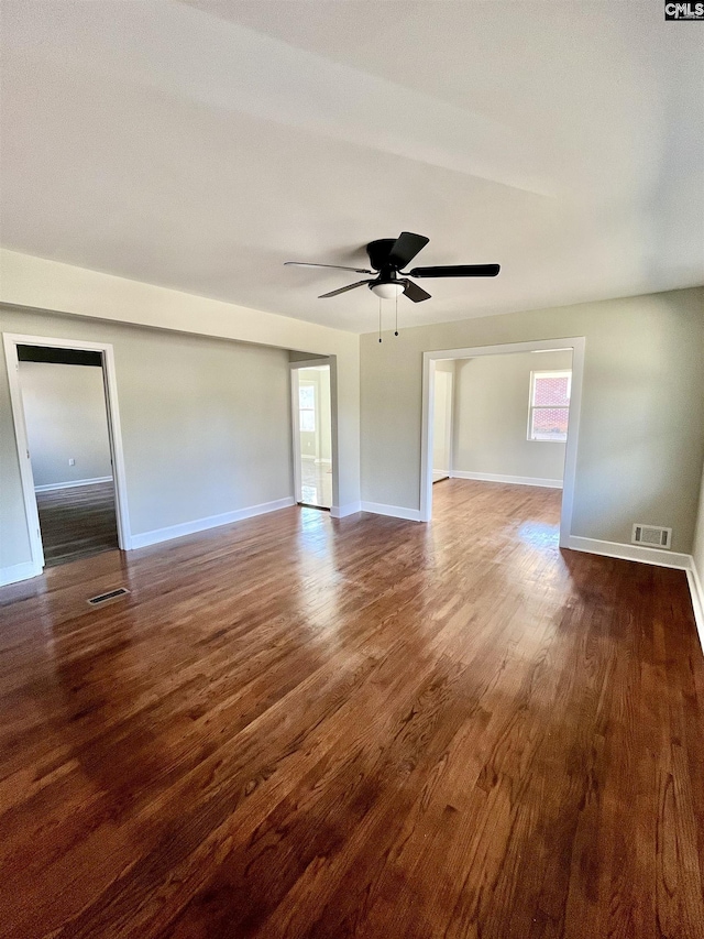 spare room with dark wood-type flooring and ceiling fan