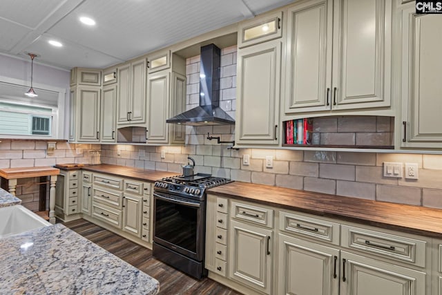 kitchen featuring butcher block countertops, decorative light fixtures, backsplash, gas stove, and wall chimney range hood