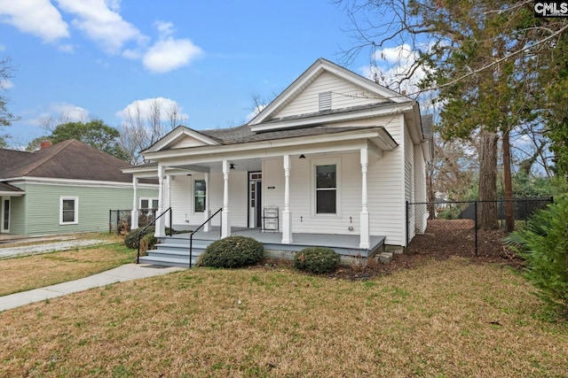 bungalow-style home with a porch and a front yard