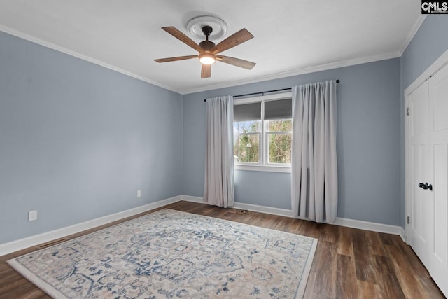 spare room featuring ceiling fan, ornamental molding, and dark hardwood / wood-style floors