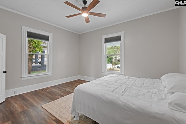 bedroom with multiple windows, crown molding, dark hardwood / wood-style floors, and ceiling fan