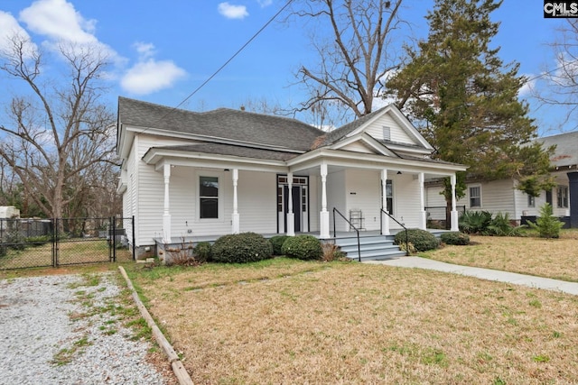 bungalow-style home with a front yard and covered porch