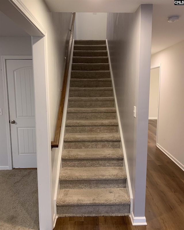 stairs with wood-type flooring