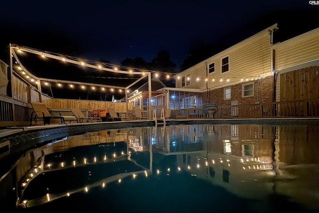 pool at twilight with a patio area