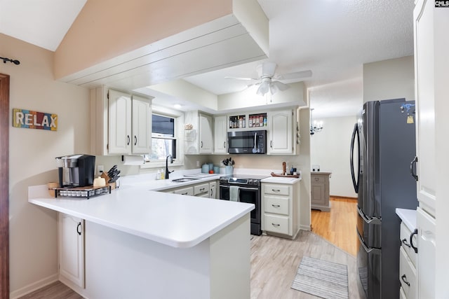 kitchen featuring sink, light hardwood / wood-style flooring, white cabinetry, stainless steel appliances, and kitchen peninsula