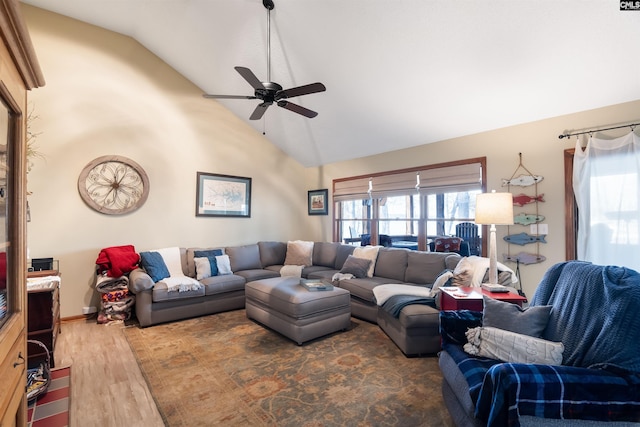 living room with ceiling fan, dark hardwood / wood-style flooring, and high vaulted ceiling