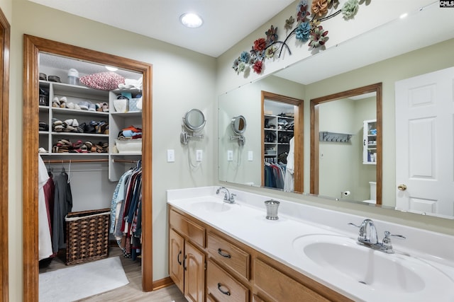 bathroom featuring vanity, hardwood / wood-style flooring, and toilet